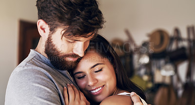 Buy stock photo Shot of an affectionate young couple sharing a romantic moment at home