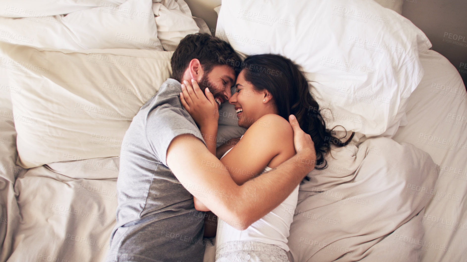 Buy stock photo Happy, bed and couple hug at morning with embrace at home with love, marriage and cuddle together. Smile, above and blanket fort in a bedroom in a house with care and romance with cotton duvet