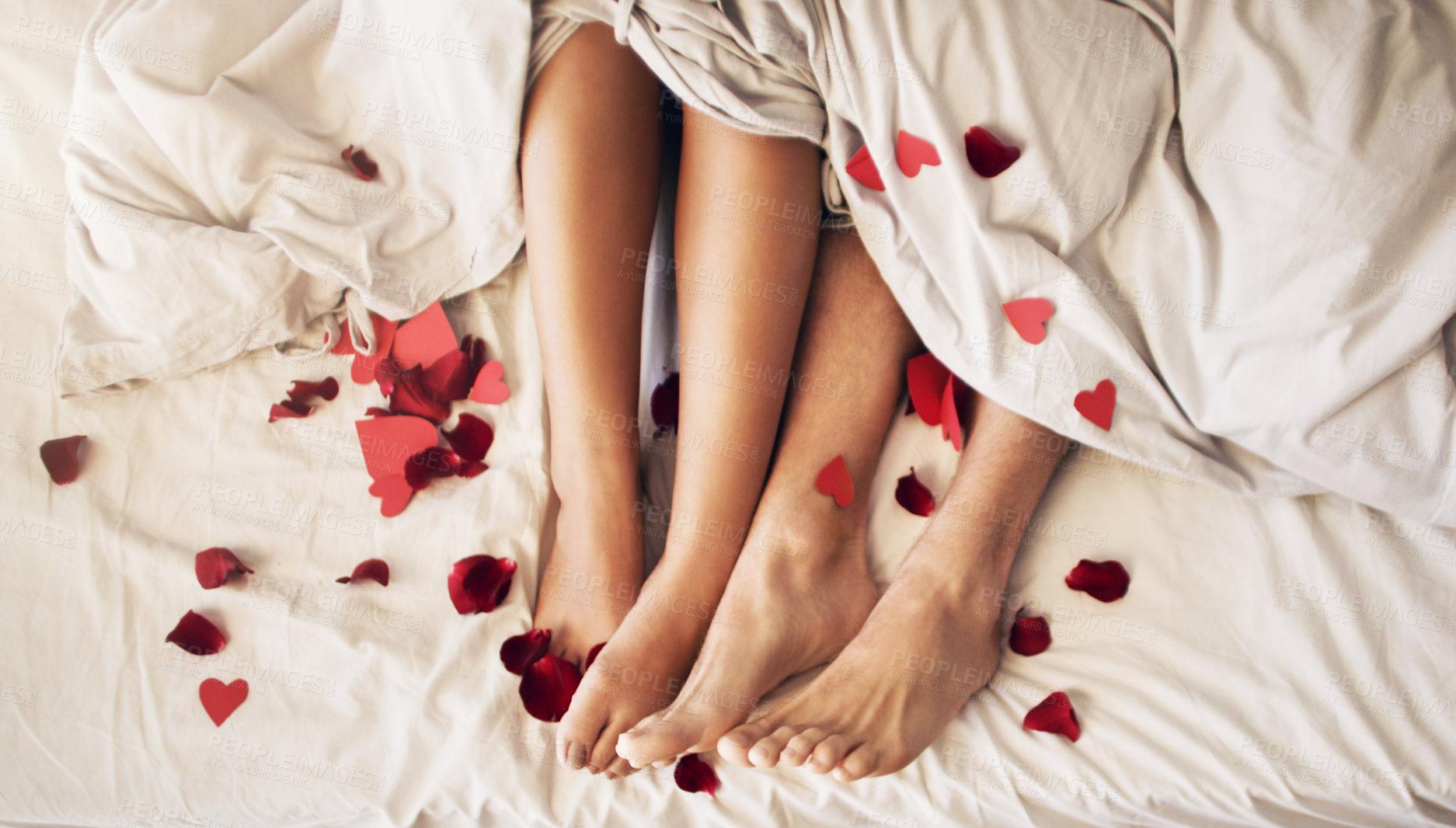 Buy stock photo Couple feet and heart in bed with love, valentines day and legs at home in morning. Bedroom, hearts and people with woman and man foot together in a house feeling romantic, relax and lazy on weekend