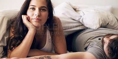 Buy stock photo Shot of a young couple relaxing in bed together at home