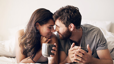 Buy stock photo Shot of a happy young couple having coffee together in bed at home