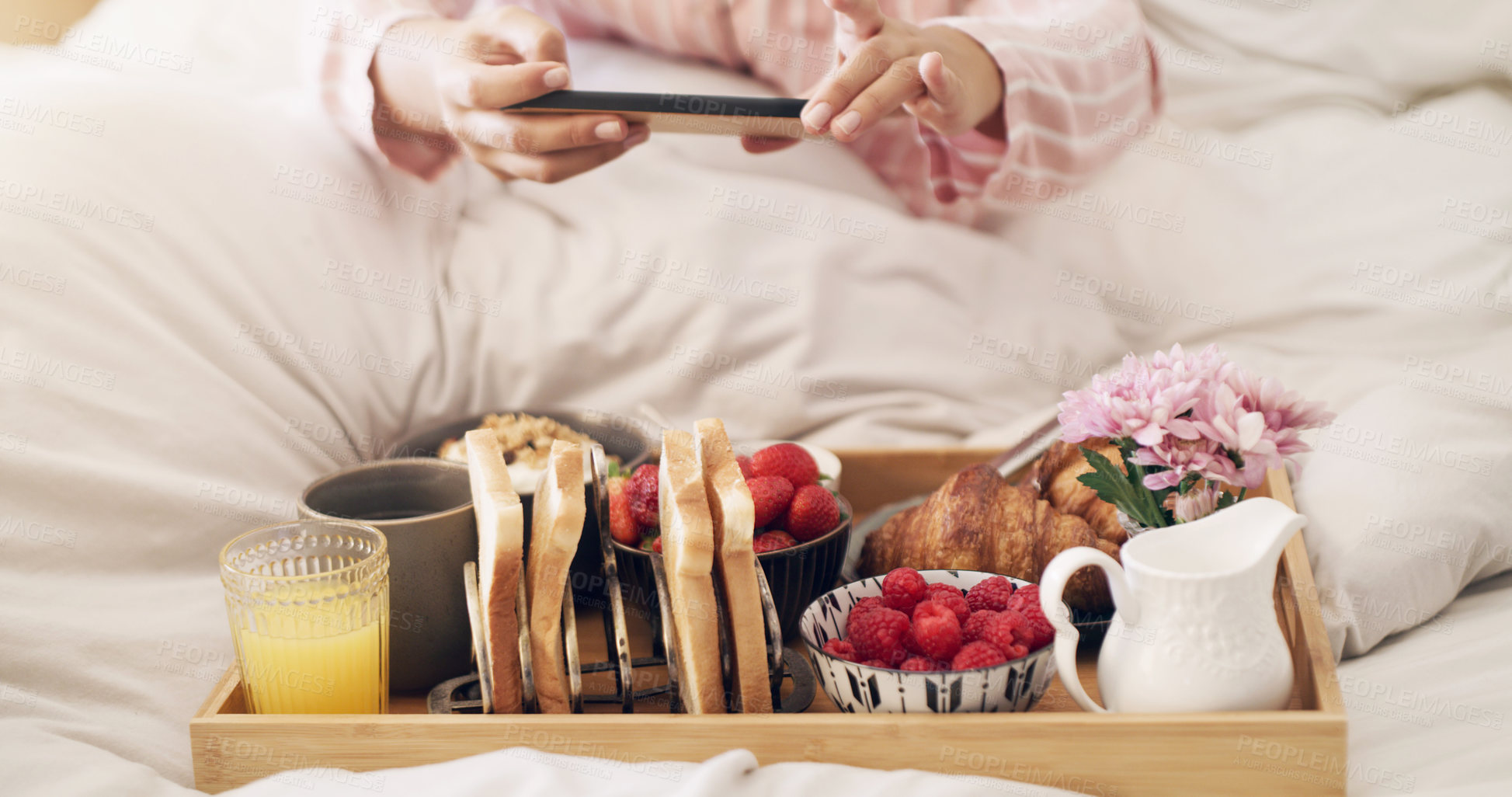 Buy stock photo Cropped shot of a woman taking a picture of her breakfast in bed at home