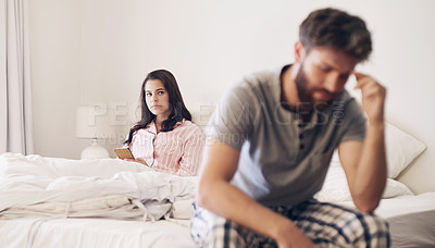 Buy stock photo Shot of a young couple having an argument in the bedroom at home
