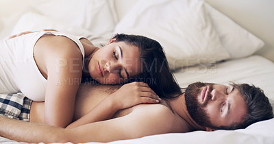 Buy stock photo Shot of a happy young couple having a nap in bed together at home