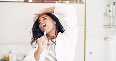Buy stock photo Shot of an attractive young woman singing while brushing her teeth at home