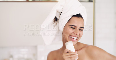 Buy stock photo Shot of an attractive young woman singing while going through her morning beauty routine at home