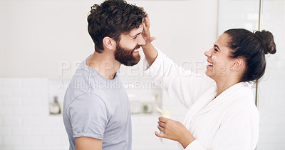 Buy stock photo Couple, face skincare cream and bathroom with smile, helping hand and morning together in home. Woman, man and skin wellness for help, care or laughing with product for lifestyle, beauty or health