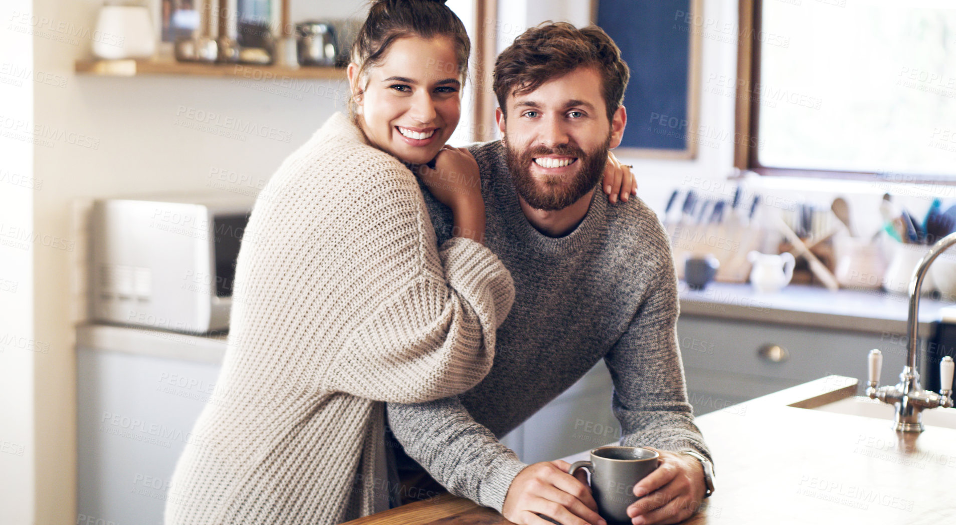 Buy stock photo Shot of a happy young couple having coffee together in the kitchen at home