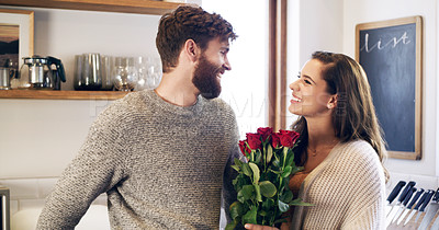 Buy stock photo Shot of a young man surprising his wife with a bunch of roses at home