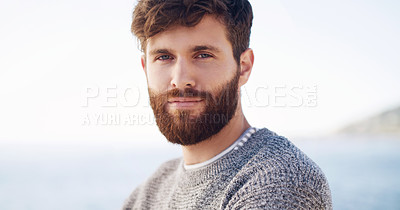 Buy stock photo Cropped shot of a handsome young man spending the day at the beach