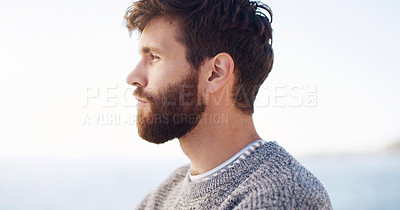 Buy stock photo Cropped shot of a handsome young man spending the day at the beach