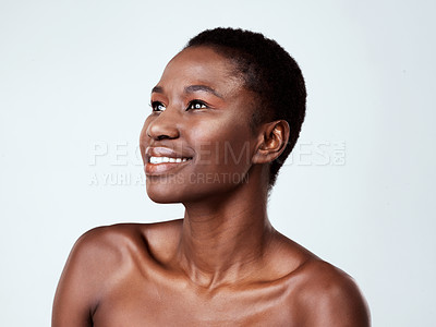 Buy stock photo Studio shot of a beautiful young woman looking thoughtful against a grey background