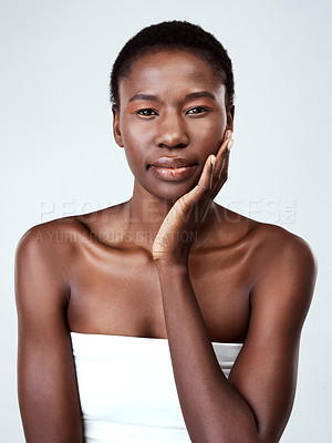 Buy stock photo Studio portrait of a beautiful young woman feeling her skin against a grey background