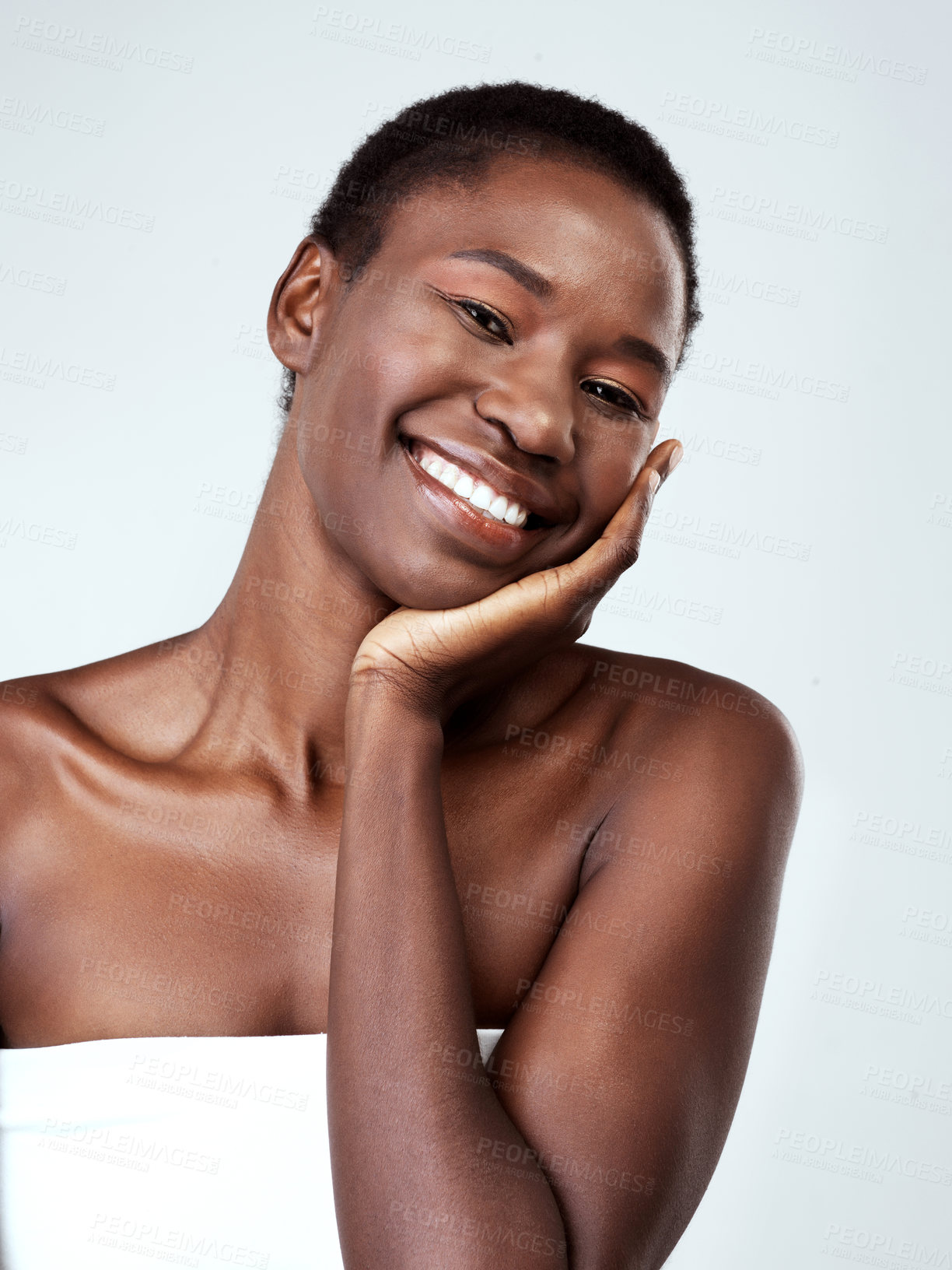 Buy stock photo Studio portrait of a beautiful young woman feeling her skin against a grey background