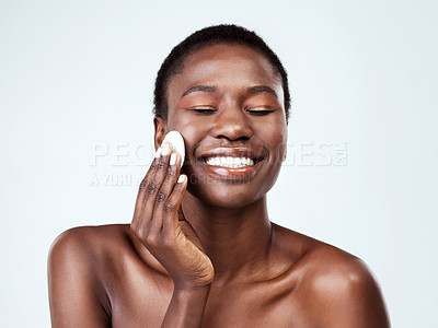 Buy stock photo Studio shot of a beautiful young woman wiping her face with cotton