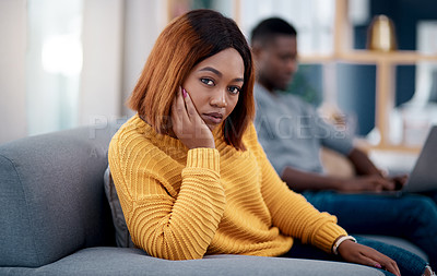 Buy stock photo Shot of a young woman looking annoyed after an argument with her boyfriend