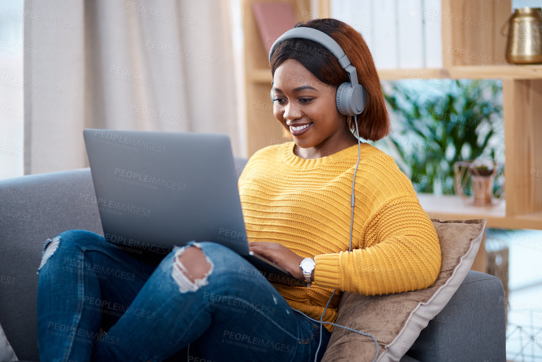 Buy stock photo Black woman with laptop, headphones and relax on sofa, search online for movie and streaming subscription at home. Happy African female person in apartment, connectivity and watching on pc with web