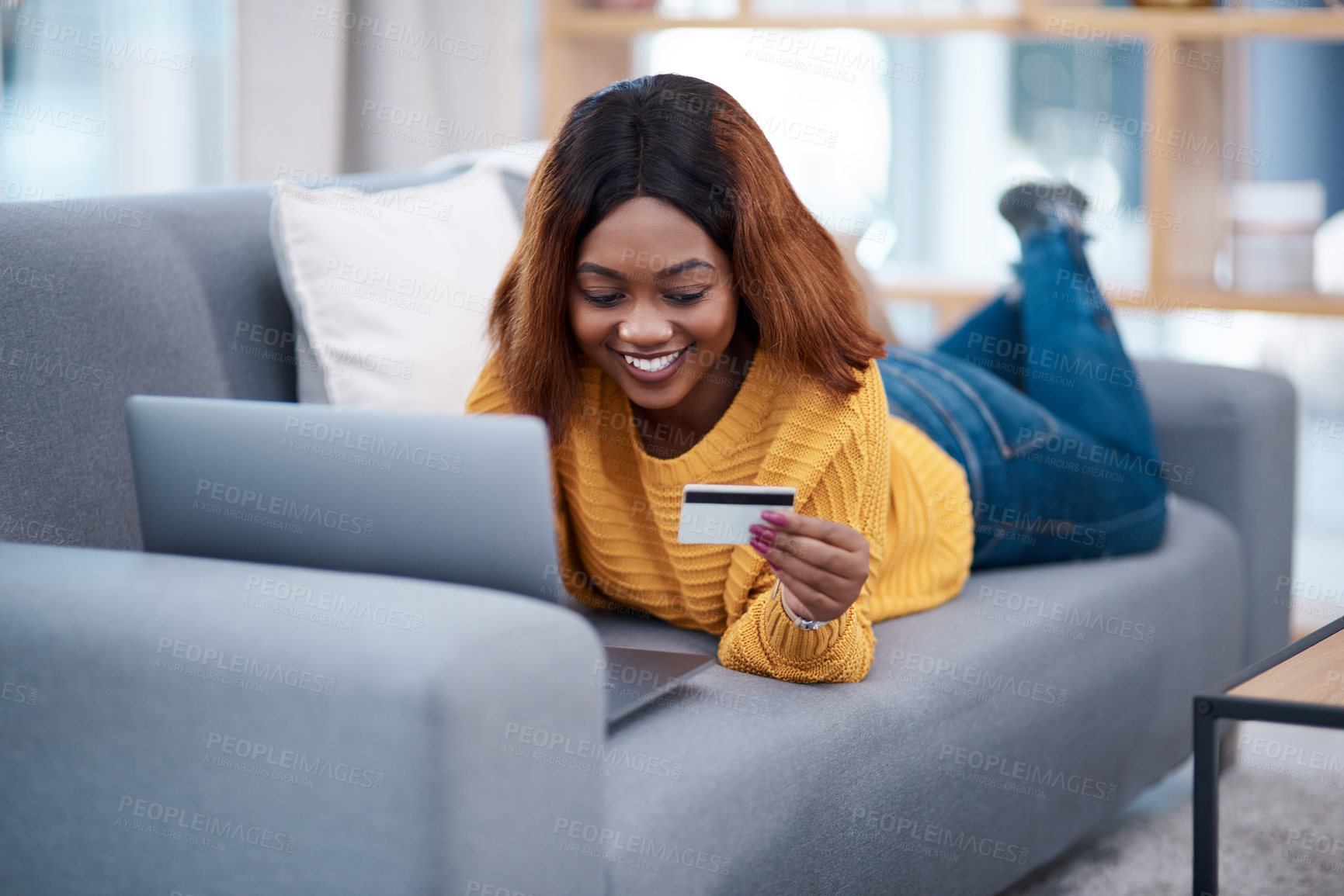 Buy stock photo Black woman, laptop and credit card with online shopping, e commerce with payment on store website and relax on sofa. Happy African female customer, bank app and finance with internet banking at home