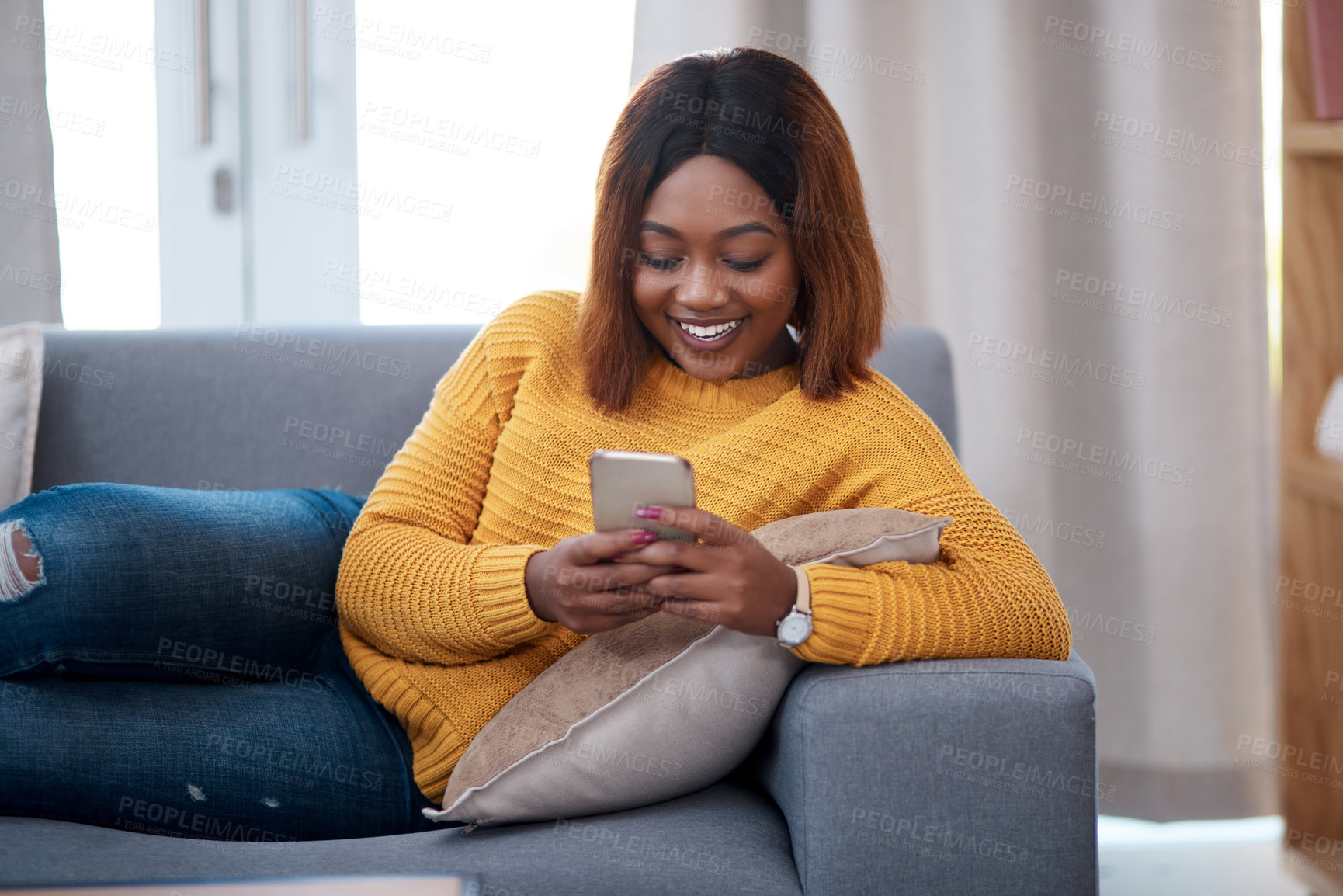 Buy stock photo Black woman with smartphone, chat on social media and relax at home, smile with online communication. African female person, mobile app with text message or post update with connectivity in apartment