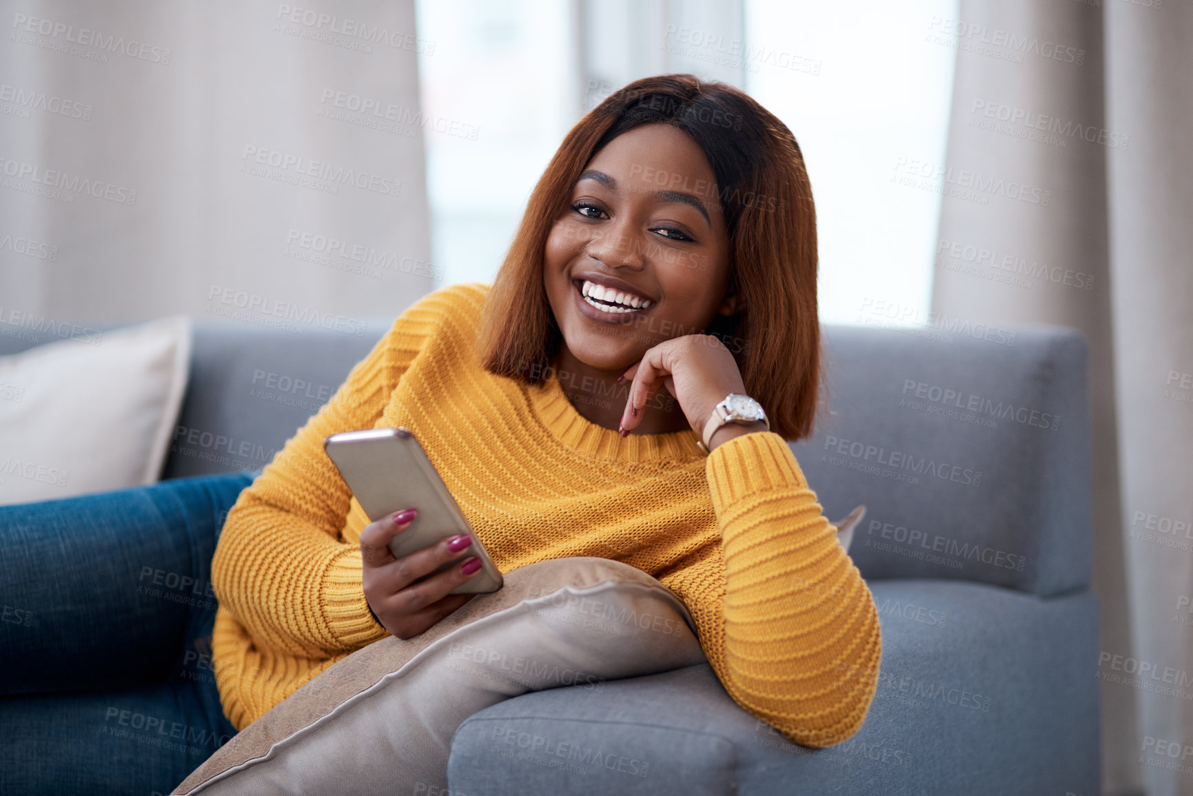 Buy stock photo Black woman using phone, chat on social media and laughing, relax at home with smile in portrait. African female person, app with text and funny meme with connectivity and communication in apartment