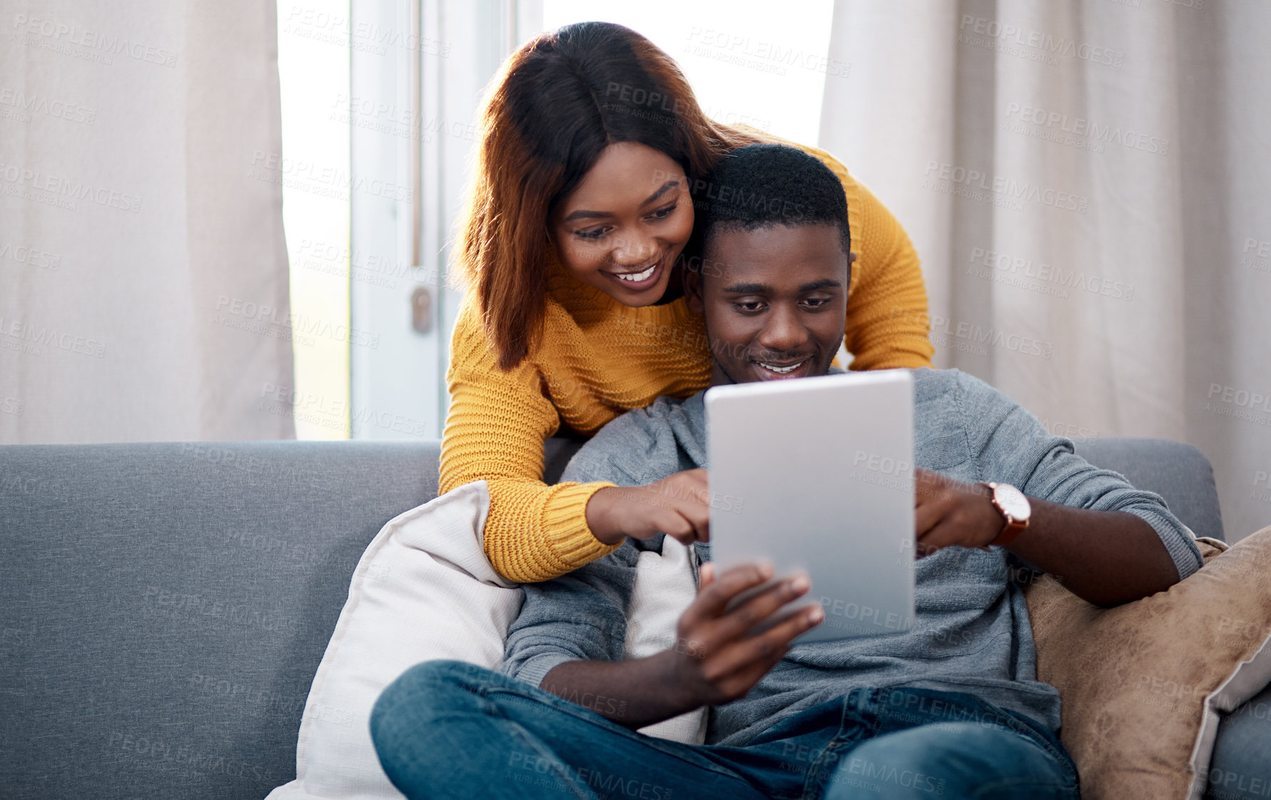 Buy stock photo Love, tablet and black couple hug on sofa with social media, streaming or sign up service choice at home. Digital, search and app for online shopping, ecommerce or checking discount deal in house