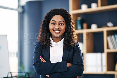 Buy stock photo Shot of a young confident businesswoman working in a modern office