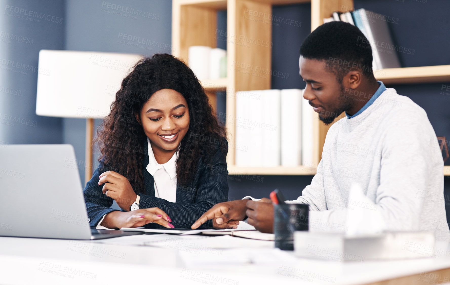 Buy stock photo Teamwork, black woman and man at desk with tablet, laptop or paperwork for sharing ideas. Collaboration, opinion and business people in office for partnership, plan and growth for online development.