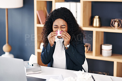 Buy stock photo Shot of a young businesswoman blowing her nose with a tissue at her desk in a modern office