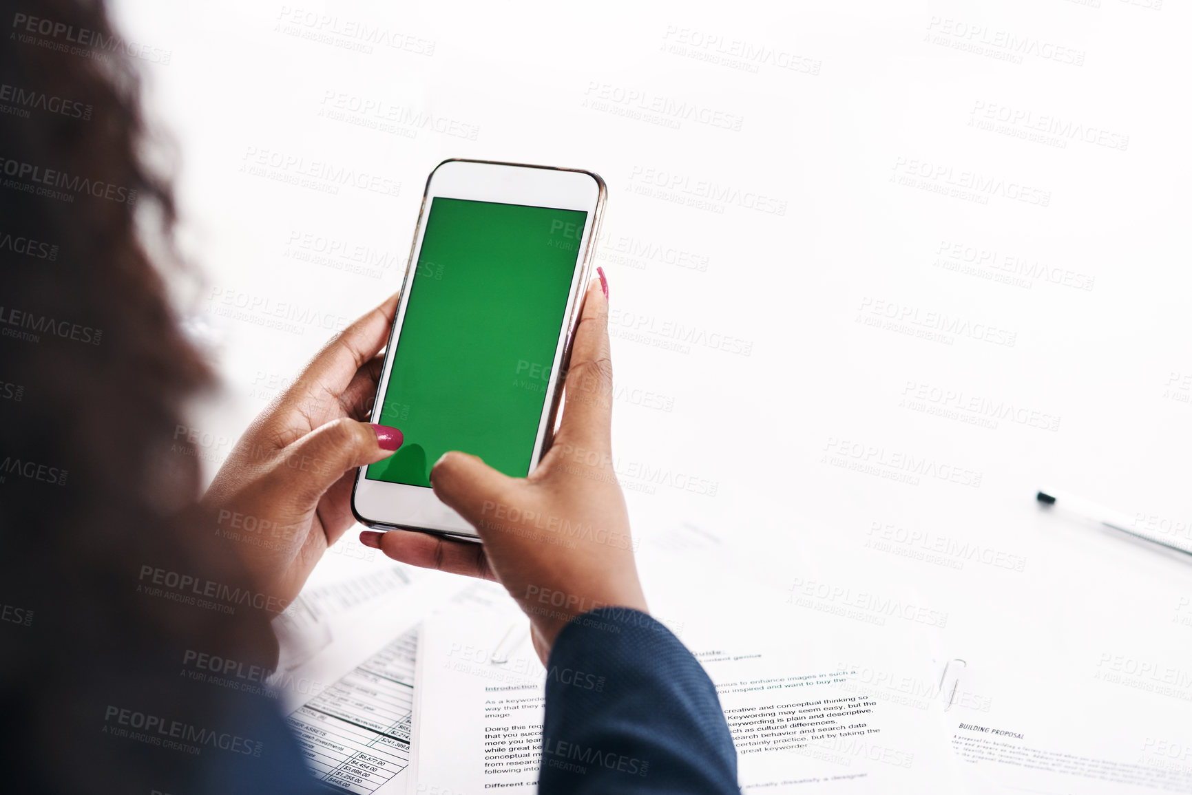 Buy stock photo Cropped shot of an unrecognizable businesswoman using a smartphone with a green screen in a modern office