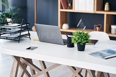 Buy stock photo Office desk, business workspace and laptop with professional setup at digital marketing startup. Workstation, paperwork and notebook with work supplies, technology and pc on table in empty workplace