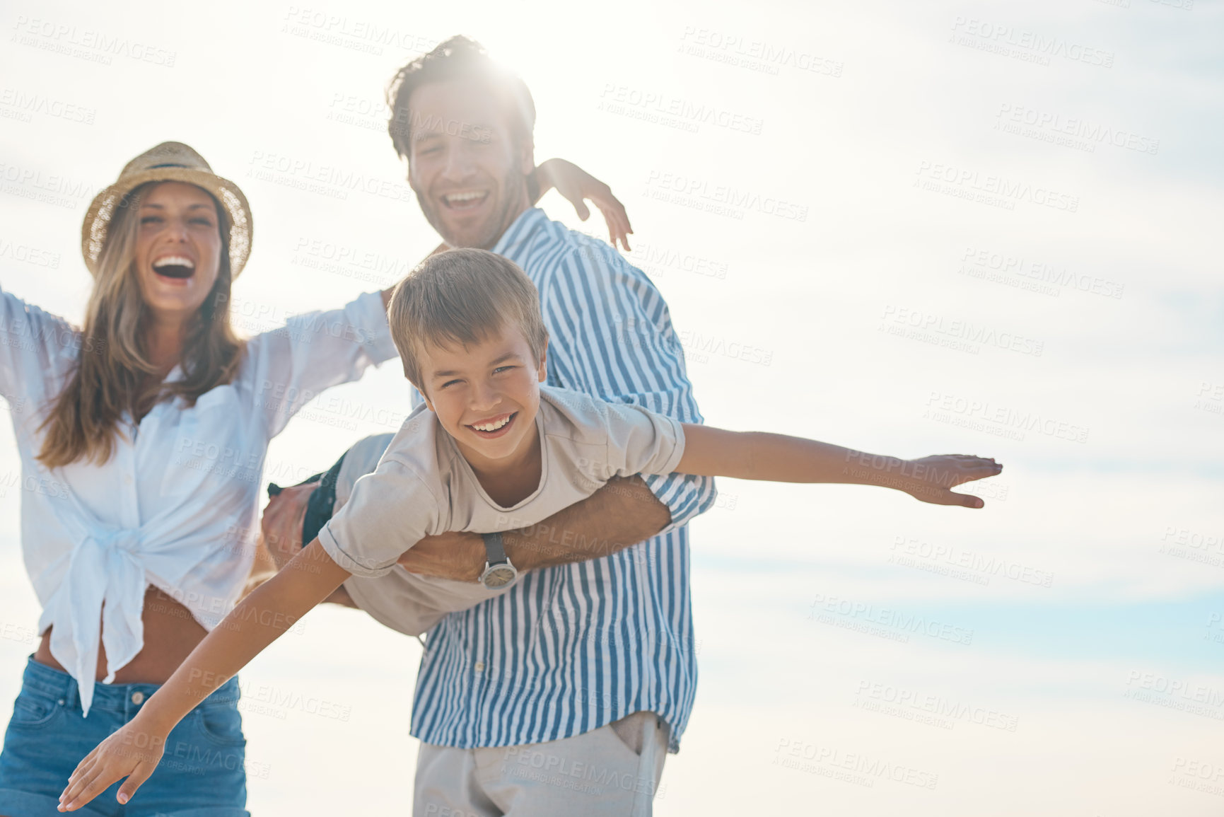 Buy stock photo Airplane, beach and portrait of child with parents for playing on holiday, vacation and weekend. Family, happy and young girl, mother and father by seaside for bonding, playful relationship and fun