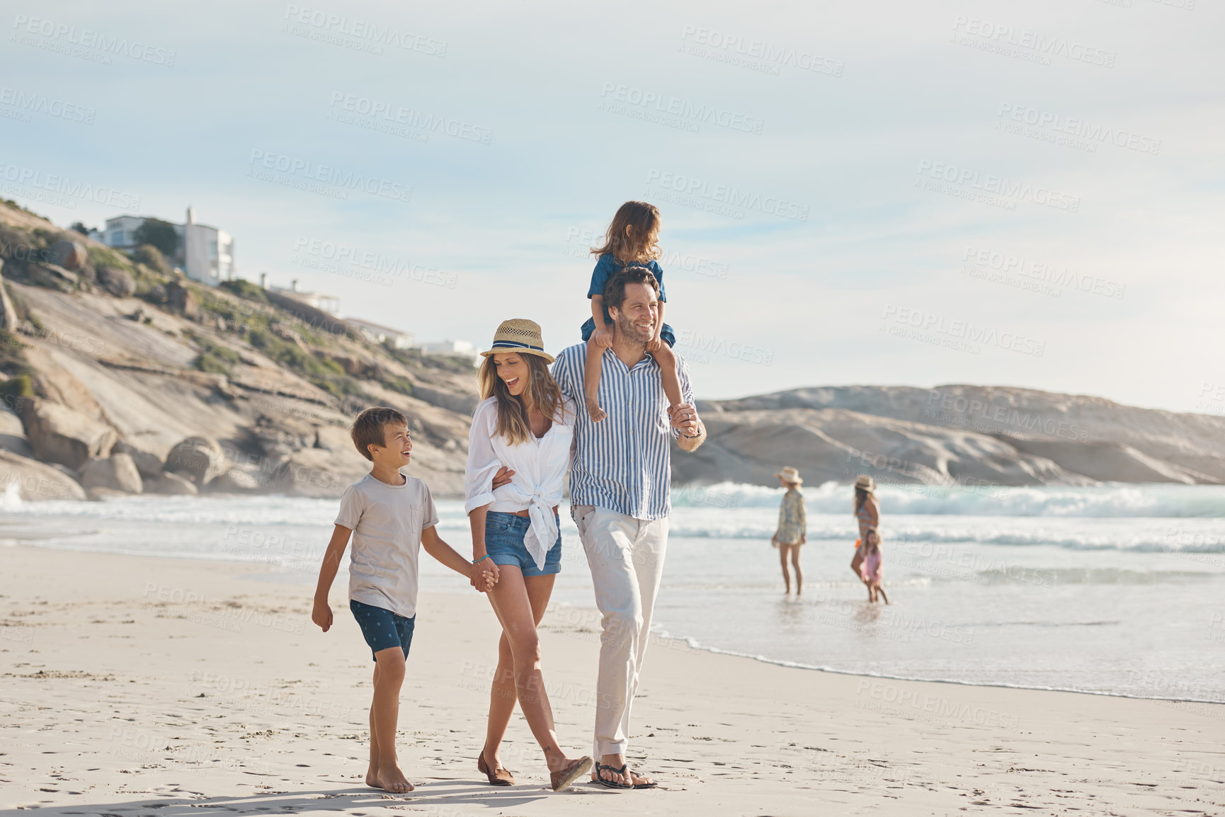 Buy stock photo Family, walking and carrying on beach for holiday, travel and bonding together in summer with sand or water. Woman, dad and kids by ocean for fun trip, vacation and relationship with holding hands