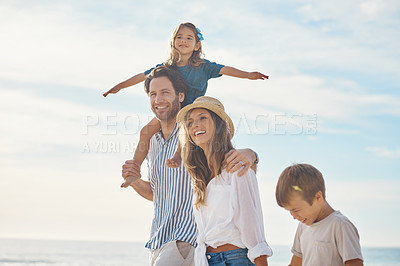 Buy stock photo Cropped shot of a happy couple bonding with their two children during a day out on the beach together