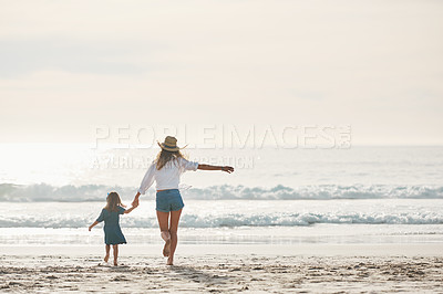 Buy stock photo Mom, girl and back by ocean with freedom on summer vacation, journey and seaside adventure for memories. Mother, female child and holding hands on beach on holiday, together and bonding with love.