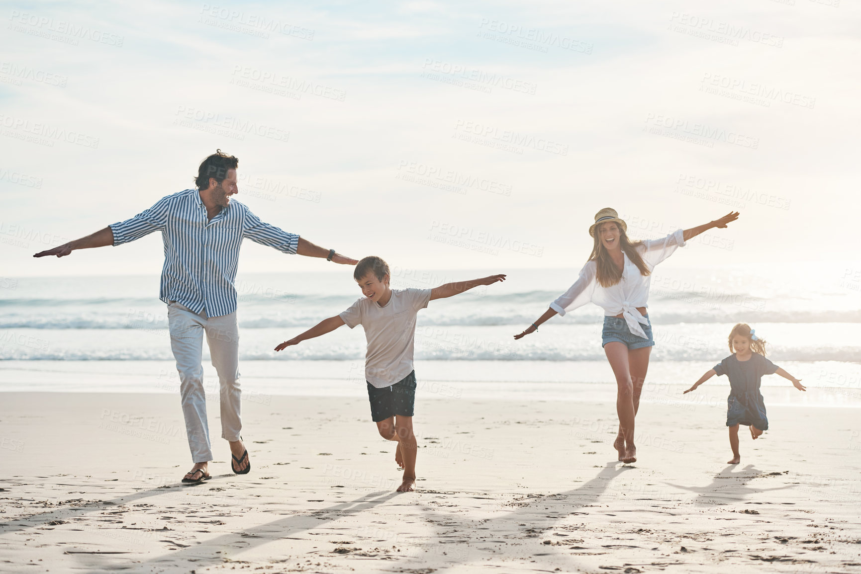 Buy stock photo Beach, run and airplane with family play, flying and happy adventure by ocean on blue sky. Freedom, game and children running with parents in Miami shore for holiday travel, trip and summer vacation