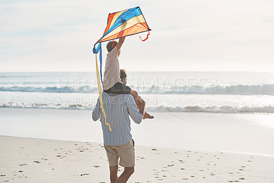 Buy stock photo Carry, family and flying kite on beach together for holiday, travel or vacation in summer. Back, love or walking with father and son on shoulder at tropical coast by ocean for bonding or freedom