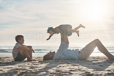 Buy stock photo Cropped shot of an affectionate mature father bonding with his two children during a day on the beach together
