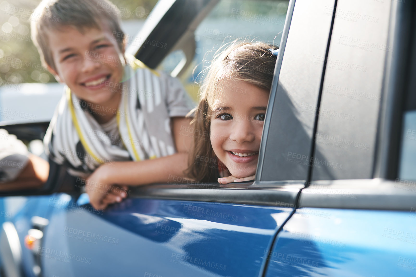 Buy stock photo Cropped portrait of two young children looking out the window of the car while waiting to go on a roadtrip