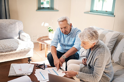 Buy stock photo Shot of a senior couple going through paperwork at home