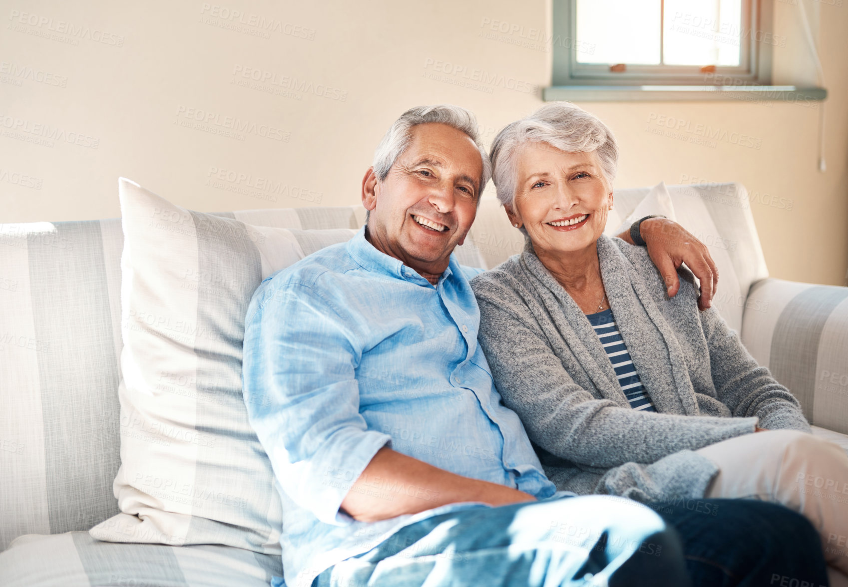 Buy stock photo Hug, portrait and happy senior couple on sofa for connection, bonding and relaxing together at home. Smile, love and elderly man and woman hugging for resting in living room at house in Switzerland.