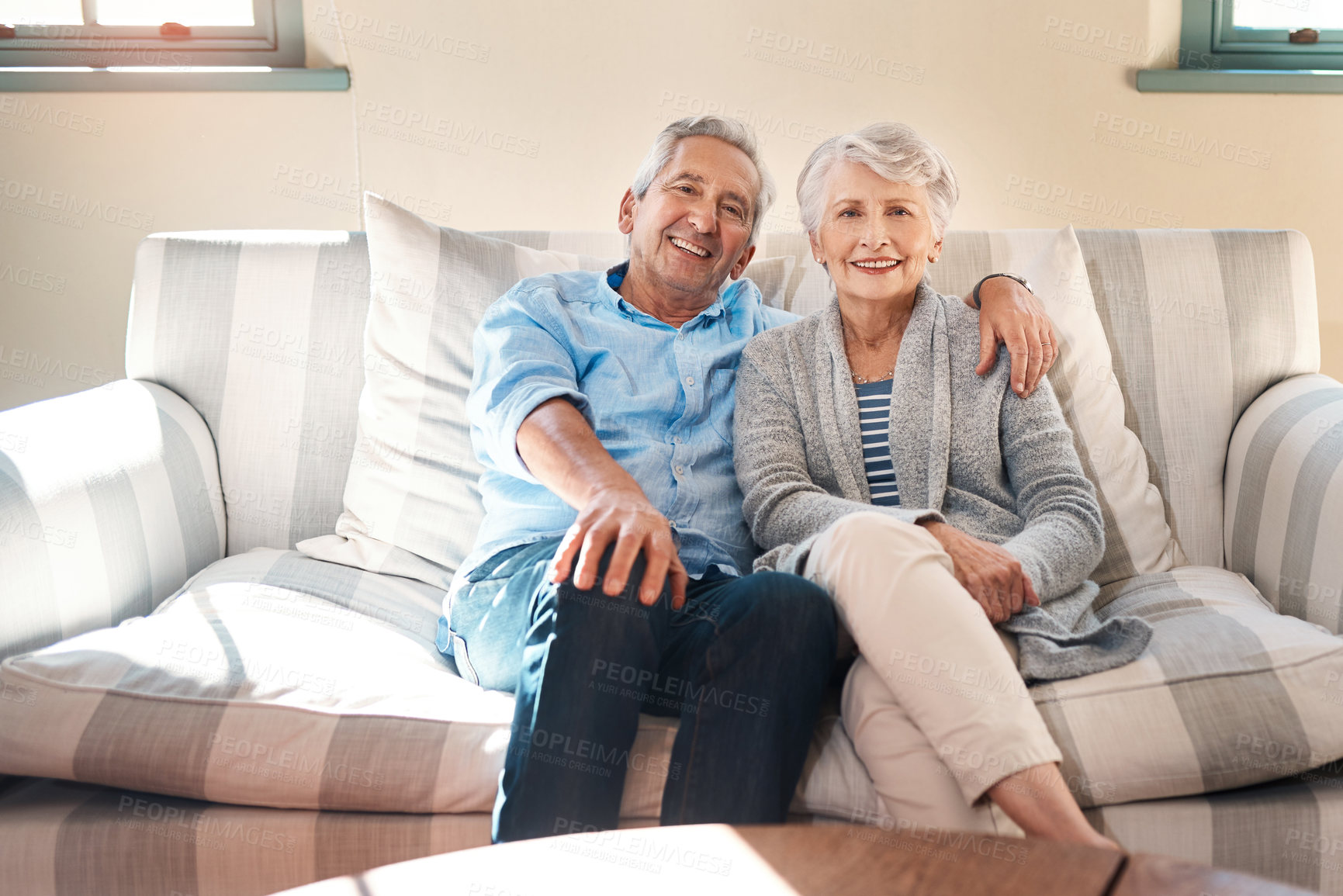 Buy stock photo Smile, portrait and senior couple on sofa for connection, bonding and relaxing together at home. Happy, love and elderly man and woman hugging for resting in living room at house in Switzerland.