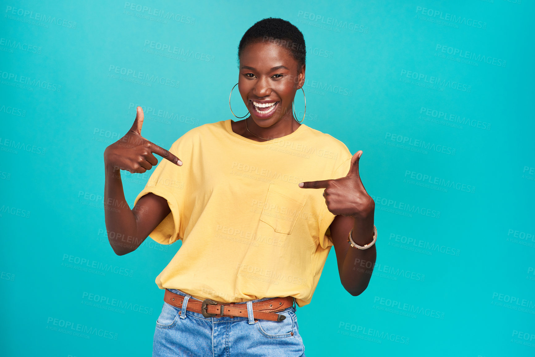 Buy stock photo Portrait, crazy and pointing with a black woman in studio on a blue background looking carefree or silly. Smile, fashion and fun with a happy young female hipster feeling confident or playful