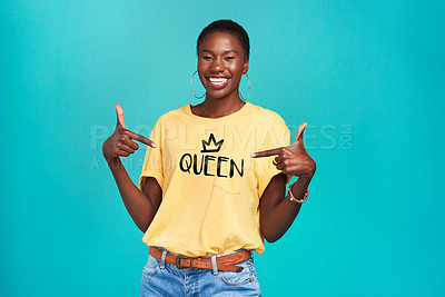 Buy stock photo Queen, print and tshirt on a black woman for equality and human rights isolated in a blue background studio. Fashion, fearless and African gen z or female person happy with quotes in her clothes