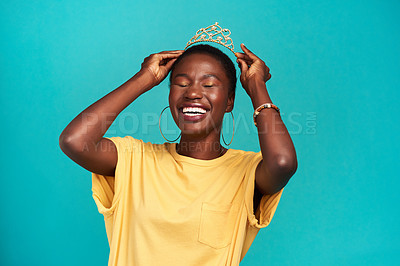 Buy stock photo Crown, happy and excited princess or black woman with happiness isolated in a blue background studio. Celebration, winner and young female person celebrating with a tiara for an achievement or prom