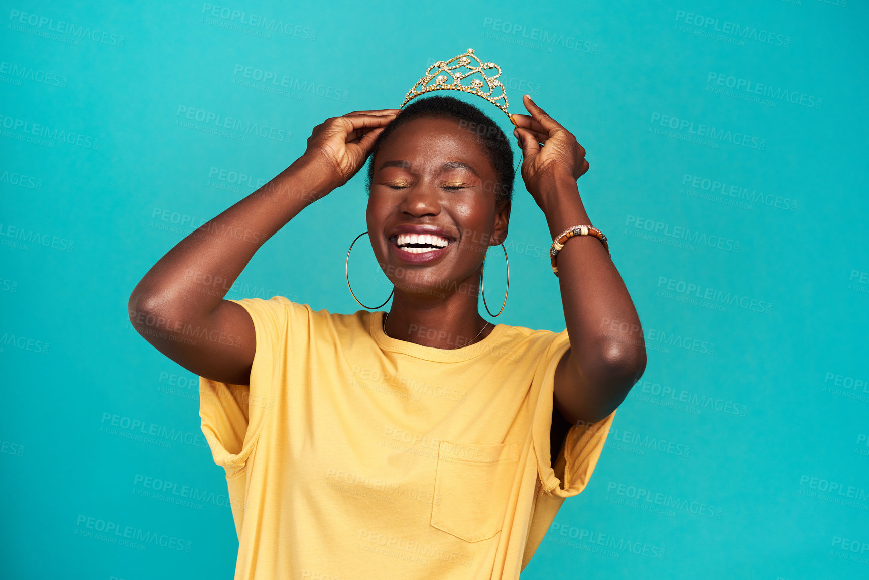 Buy stock photo Crown, happy and excited princess or black woman with happiness isolated in a blue background studio. Celebration, winner and young female person celebrating with a tiara for an achievement or prom