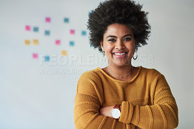 Buy stock photo Portrait of an attractive young businesswoman posing with her arms folded at work