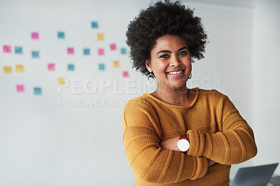 Buy stock photo Portrait of an attractive young businesswoman posing with her arms folded at work