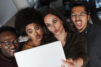 Buy stock photo Shot of a group of young businesspeople taking selfies together with a digital tablet at work