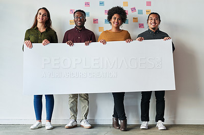 Buy stock photo Full length shot of a group of of young businesspeople holding a placard together at work