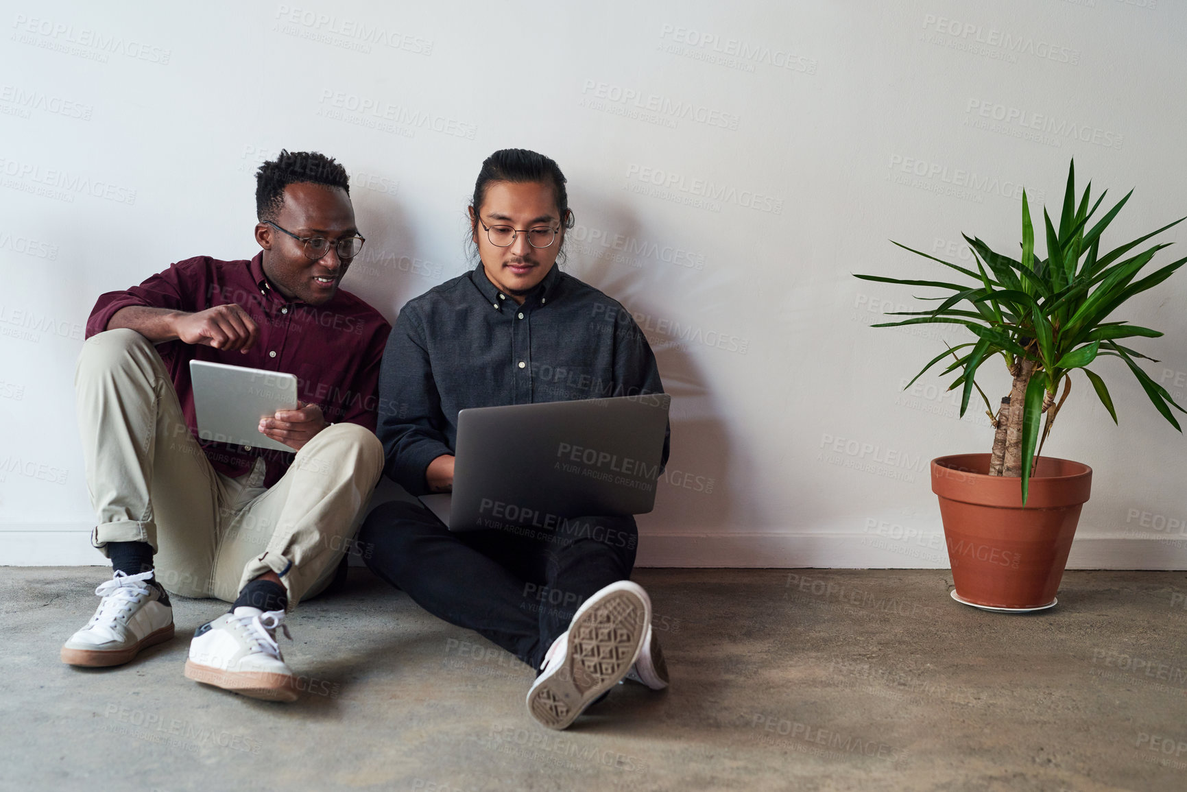 Buy stock photo Floor, laptop and tablet of business people in office, planning and research for startup in creative agency. Workplace, men or web developer with technology for layout design, solution and teamwork